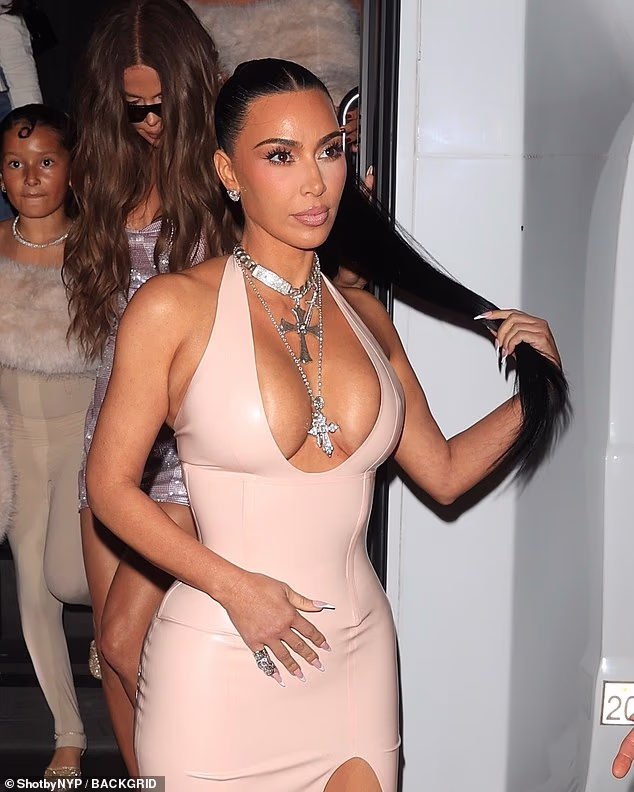 Kim Kardashian nearly spills out of VERY low-cut latex gown at sister Kylie Jenner's cosmetics pop-up event in LA