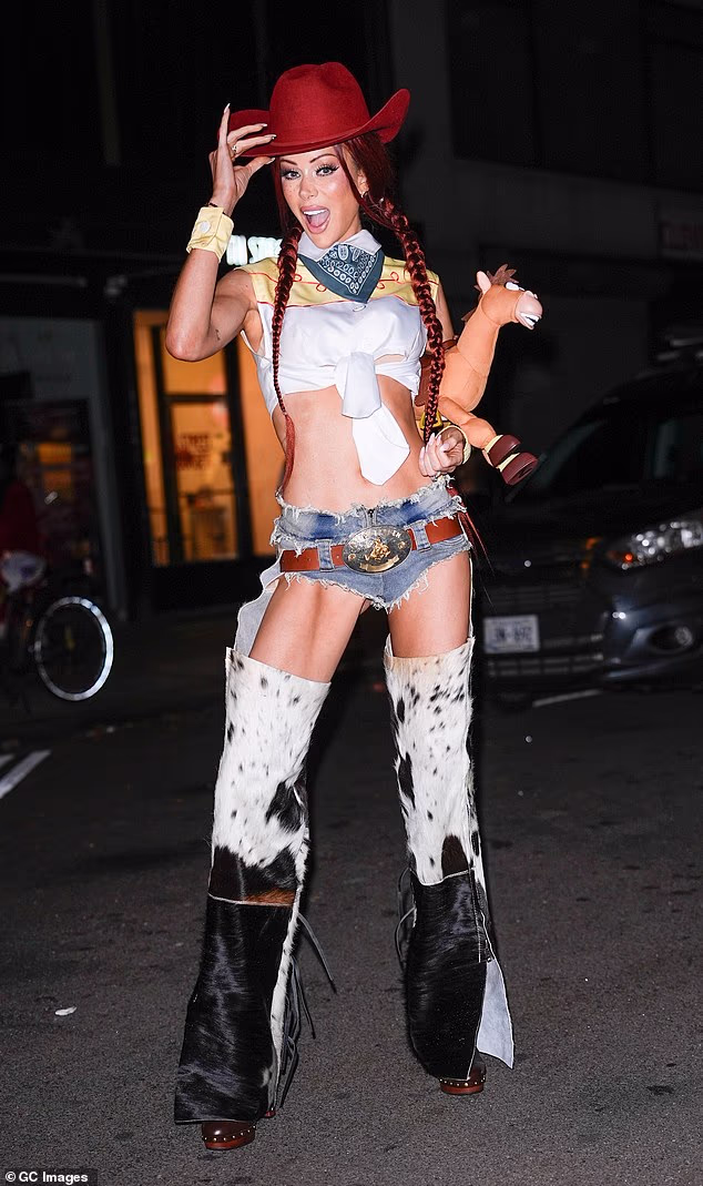 Olivia Attwood displays her washboard abs as she dresses up as Toy Story's Jessie at Heidi Klum's legendary Halloween bash