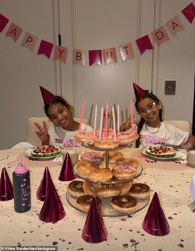 The celebrations began early when the nepo baby of Rob Kardashian enjoyed a sugary donut and fruit breakfast, during which she donned matching outfits with her seven-year-old cousin True Thompson (L)